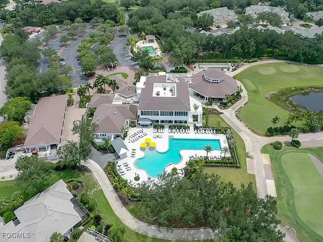 an aerial view of a house with a swimming pool outdoor seating and yard