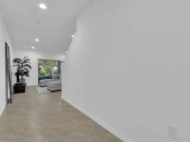 a view of a livingroom with furniture and a potted plant