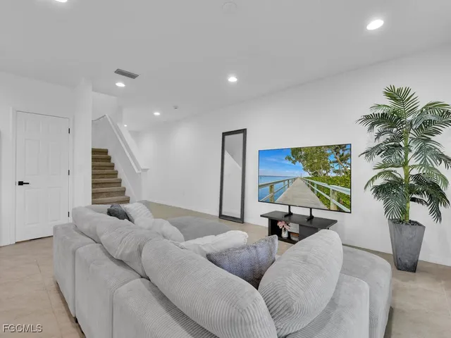 a living room with furniture and a potted plant
