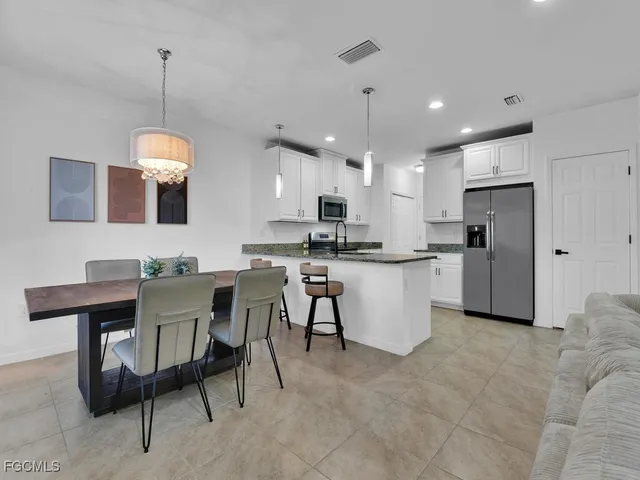 a kitchen that has a table and chairs in it