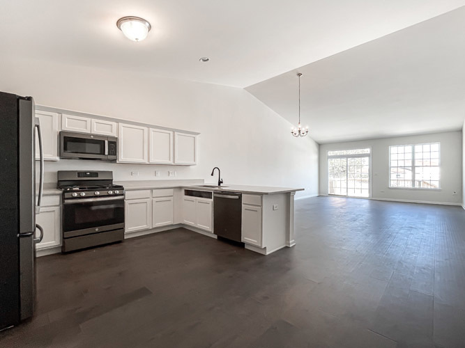 488 Ridge Road Bolingbrook, IL 60440 - Photo 4 of 16 a kitchen with stainless steel appliances kitchen island granite countertop a stove a sink and a refrigerator