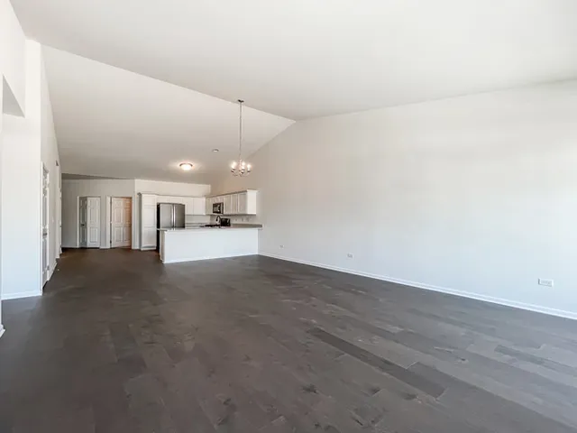 a view of a kitchen with a sink and white cabinets