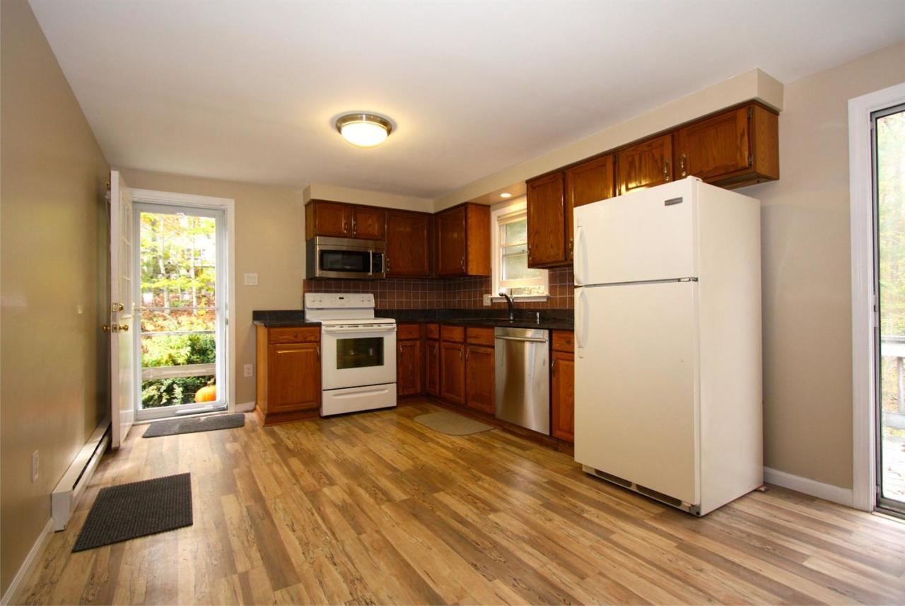 60 Scituate Road Mashpee, MA 02649 - Photo 3 of 8 a kitchen with granite countertop a refrigerator and a stove top oven