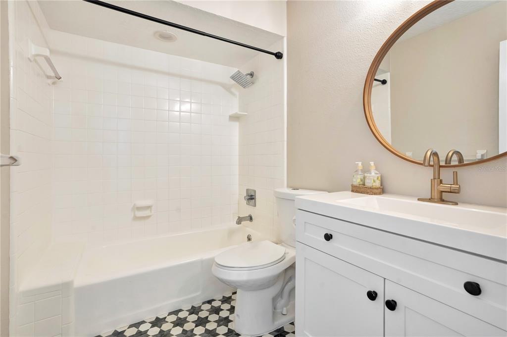 16 Raintree Court Ormond Beach, FL 32174 - Photo 22 of 37 a bathroom with a sink a toilet and a mirror