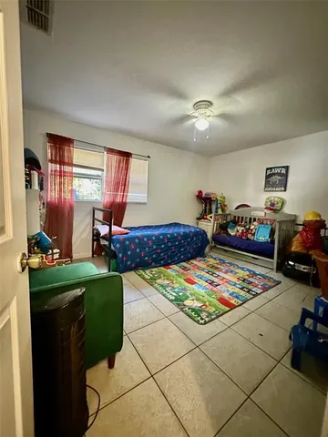 a bedroom with furniture and a window