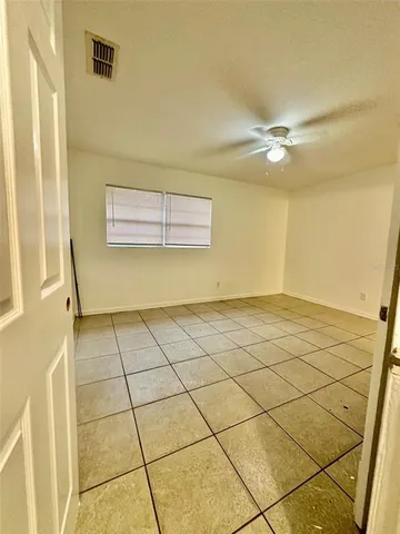 a view of a livingroom with an empty space and a chandelier fan