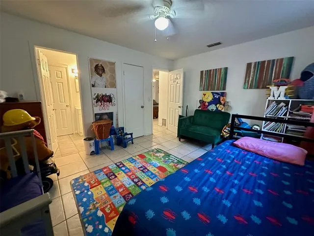 a bedroom with two beds and a chandelier