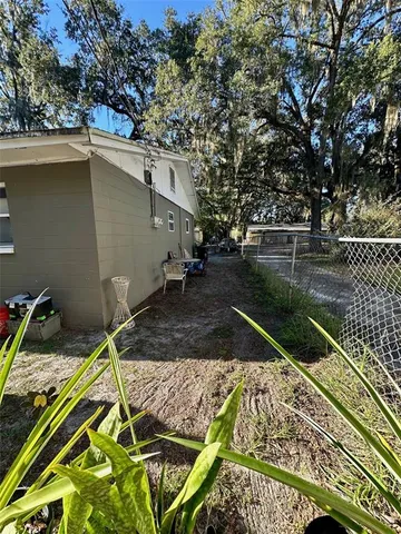 a view of a small house with backyard