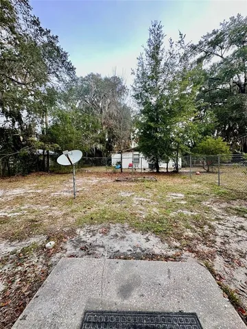 a backyard of a house with fountain and outdoor seating