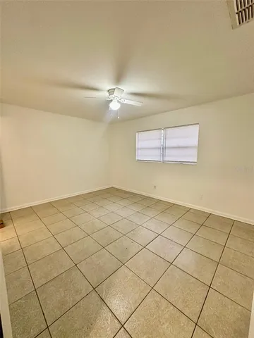 a view of a room with an empty space and a window
