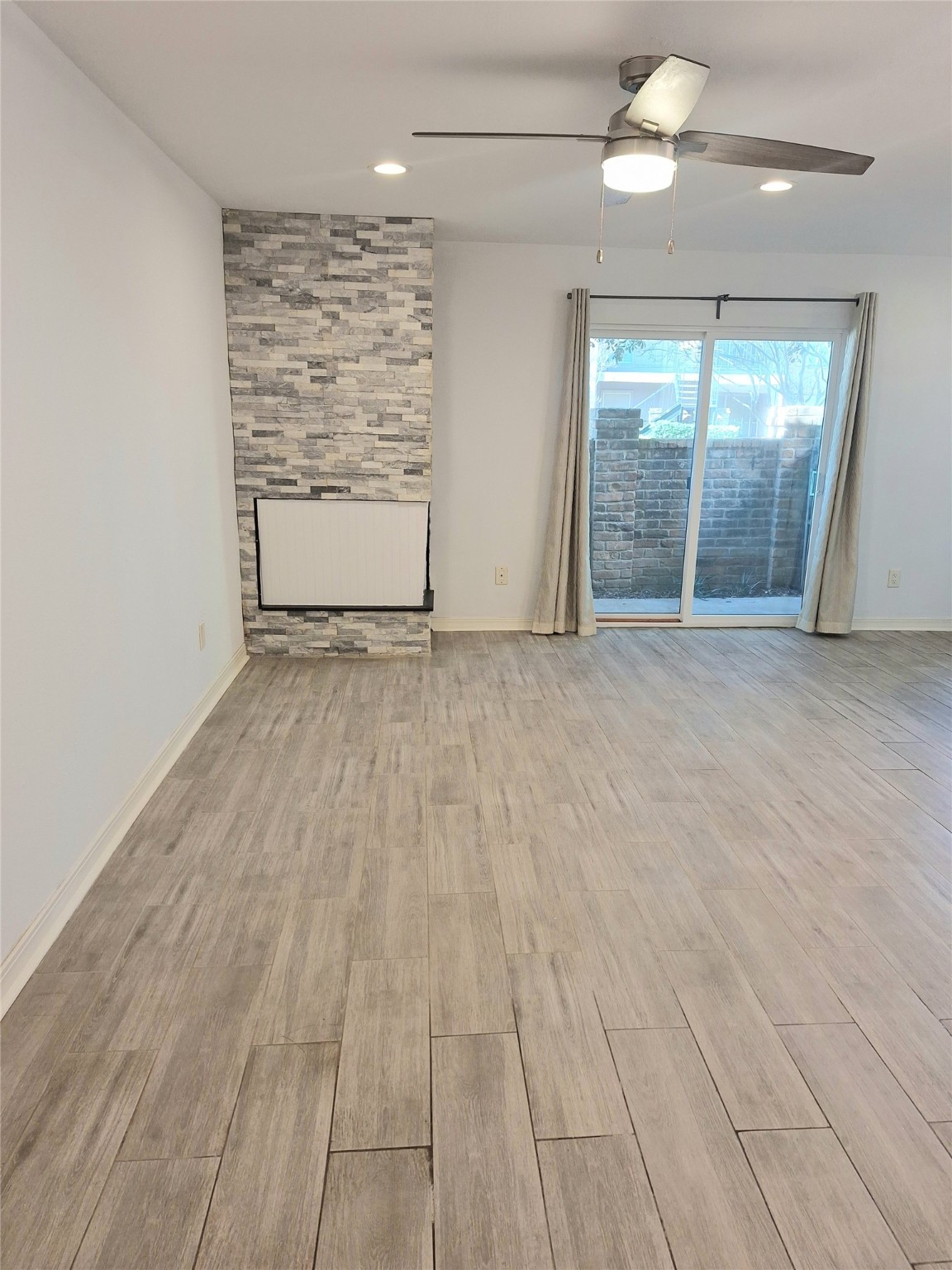 2800 Jeanetta Street, Unit 801 Houston, TX 77063 - Photo 6 of 18 an empty room with wooden floor and windows