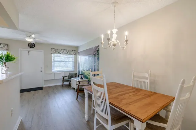 a view of a dining room with furniture wooden floor and chandelier
