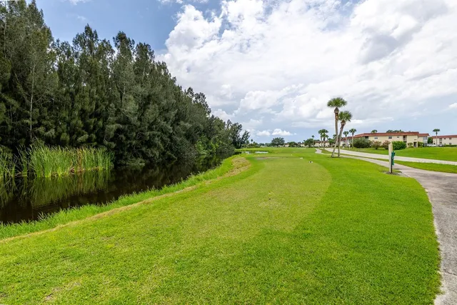 a swimming pool with outdoor seating and garden