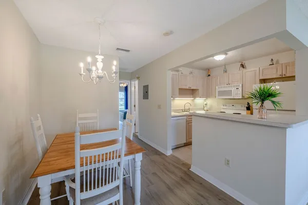 a kitchen with kitchen island a sink appliances and cabinets