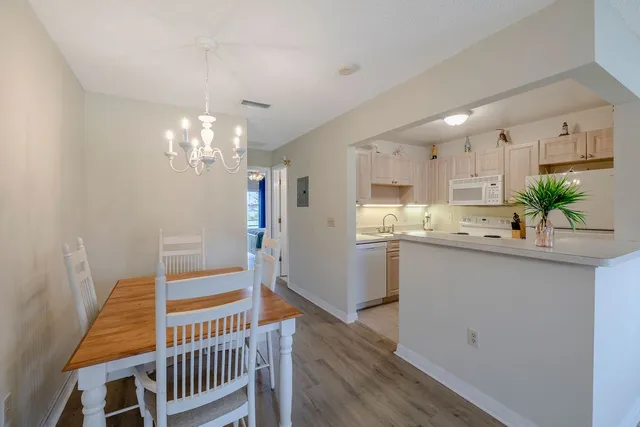 a kitchen with kitchen island a sink appliances and cabinets