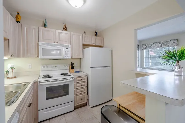 a kitchen with a stove a refrigerator and a sink