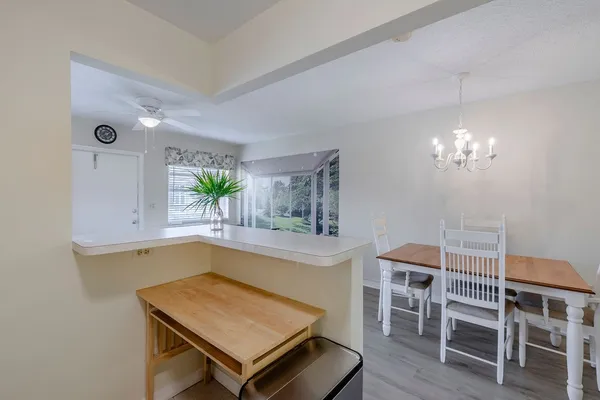 a kitchen with a table and chairs in it