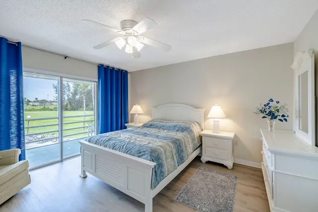 a spacious bedroom with a bed and a chandelier