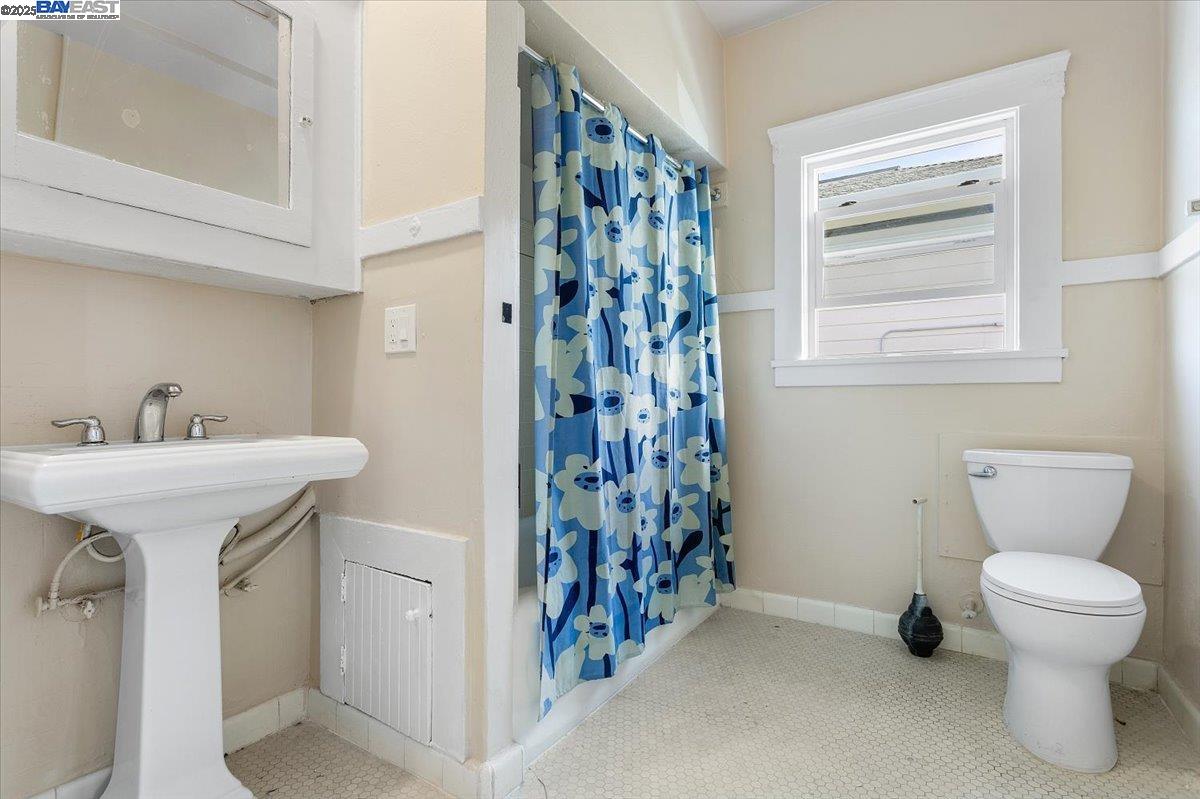 629 Santa Clara Avenue Alameda, CA 94501 - Photo 13 of 47 a bathroom with a toilet sink and mirror