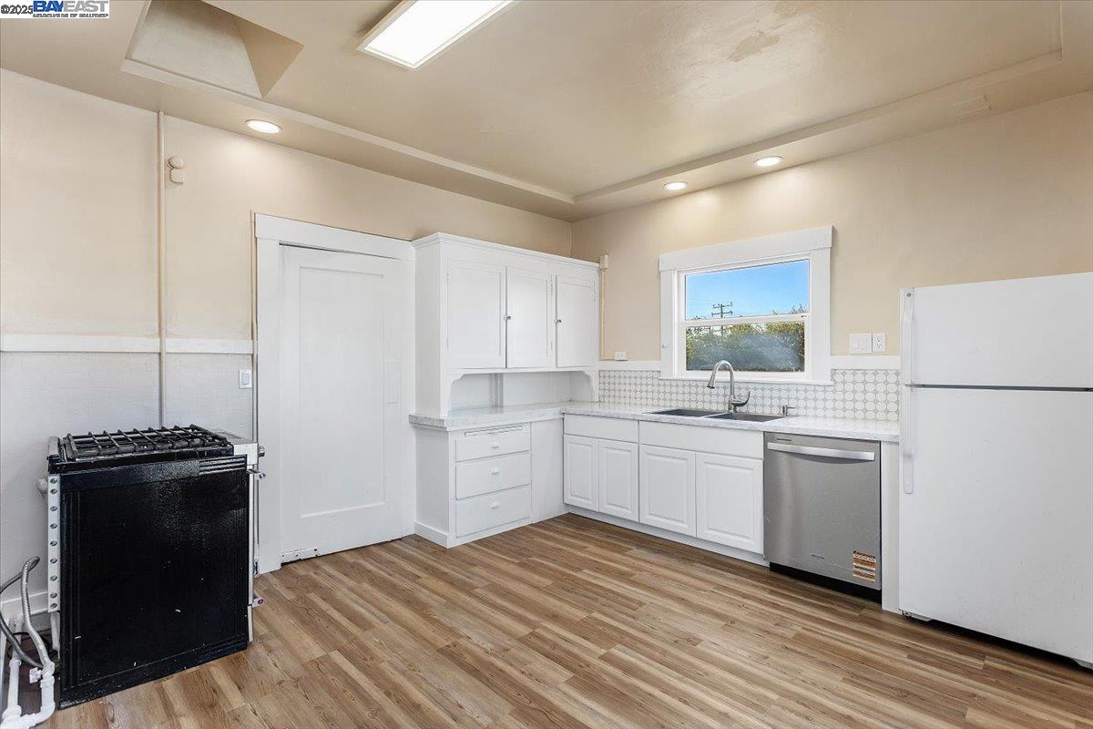 629 Santa Clara Avenue Alameda, CA 94501 - Photo 16 of 47 a kitchen with a refrigerator and white cabinets