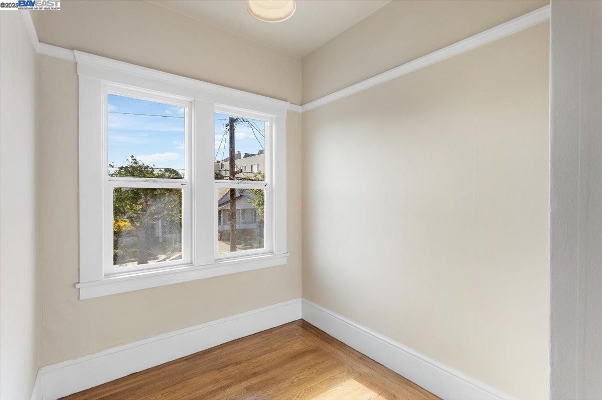 629 Santa Clara Avenue Alameda, CA 94501 - Photo 23 of 47 a view of an empty room with wooden floor and a window
