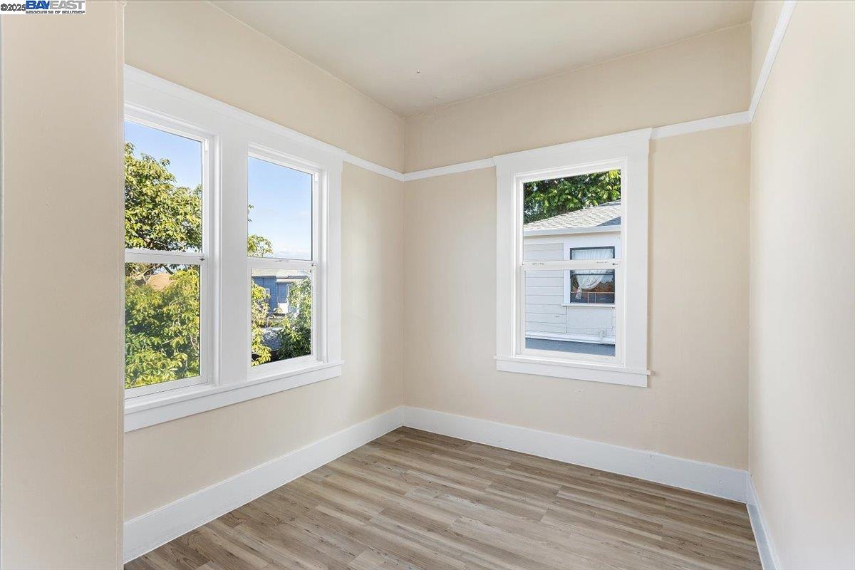 629 Santa Clara Avenue Alameda, CA 94501 - Photo 24 of 47 an empty room with wooden floor and windows