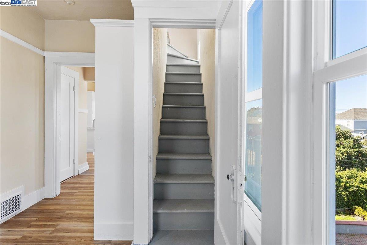 629 Santa Clara Avenue Alameda, CA 94501 - Photo 26 of 47 a view of a hallway with wooden floors and stairs
