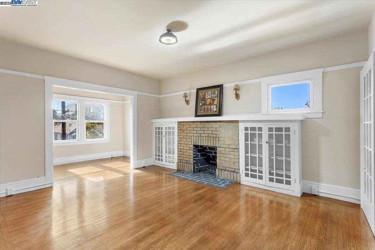 629 Santa Clara Avenue Alameda, CA 94501 - Photo 6 of 47 a view of an empty room with a fireplace and a window