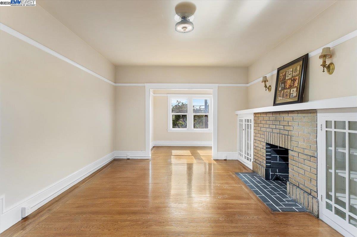 629 Santa Clara Avenue Alameda, CA 94501 - Photo 7 of 47 a view of an empty room with wooden floor and a window