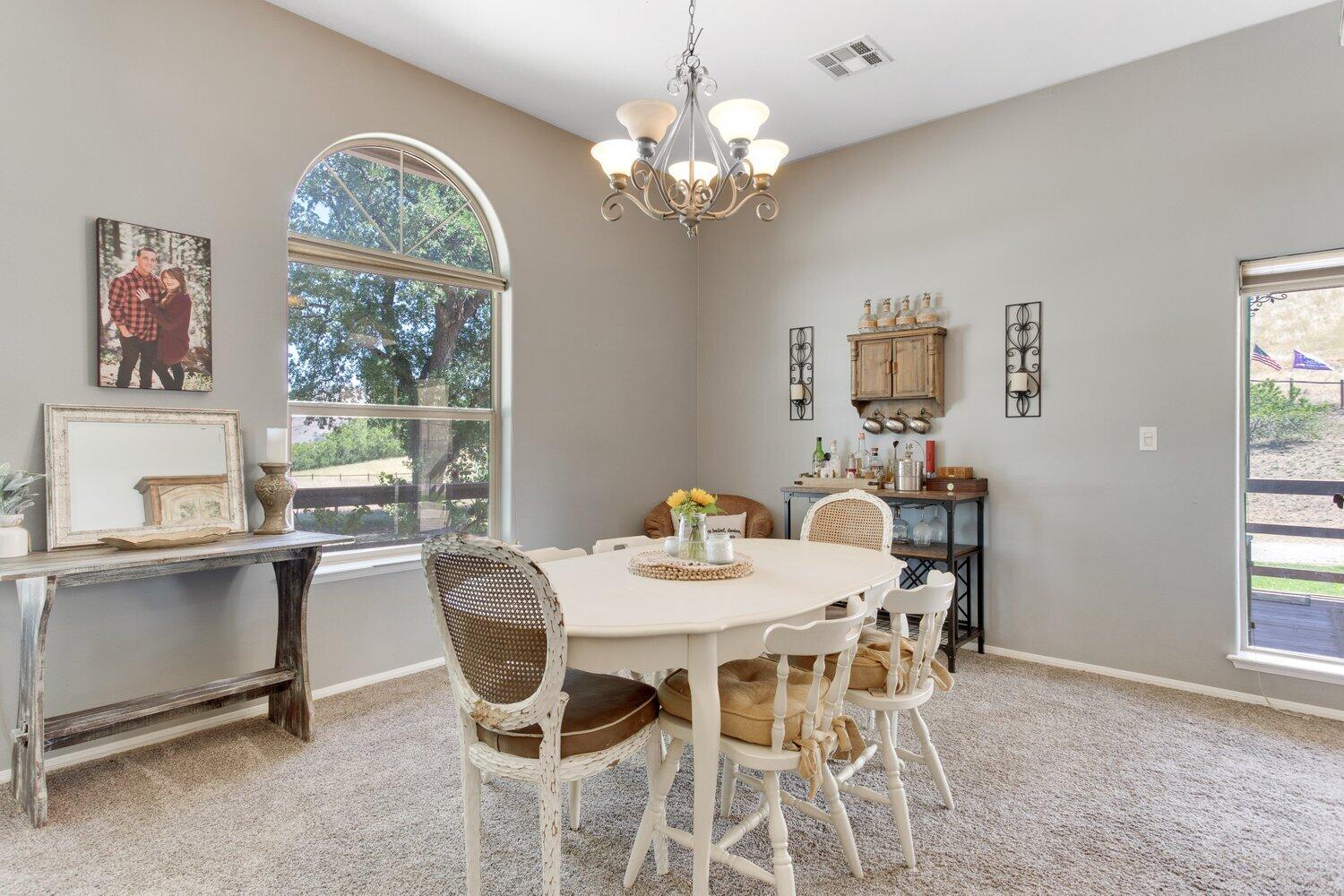 19510 Banducci Road Tehachapi, CA 93561 - Photo 14 of 75 a dining room with furniture a window and a chandelier