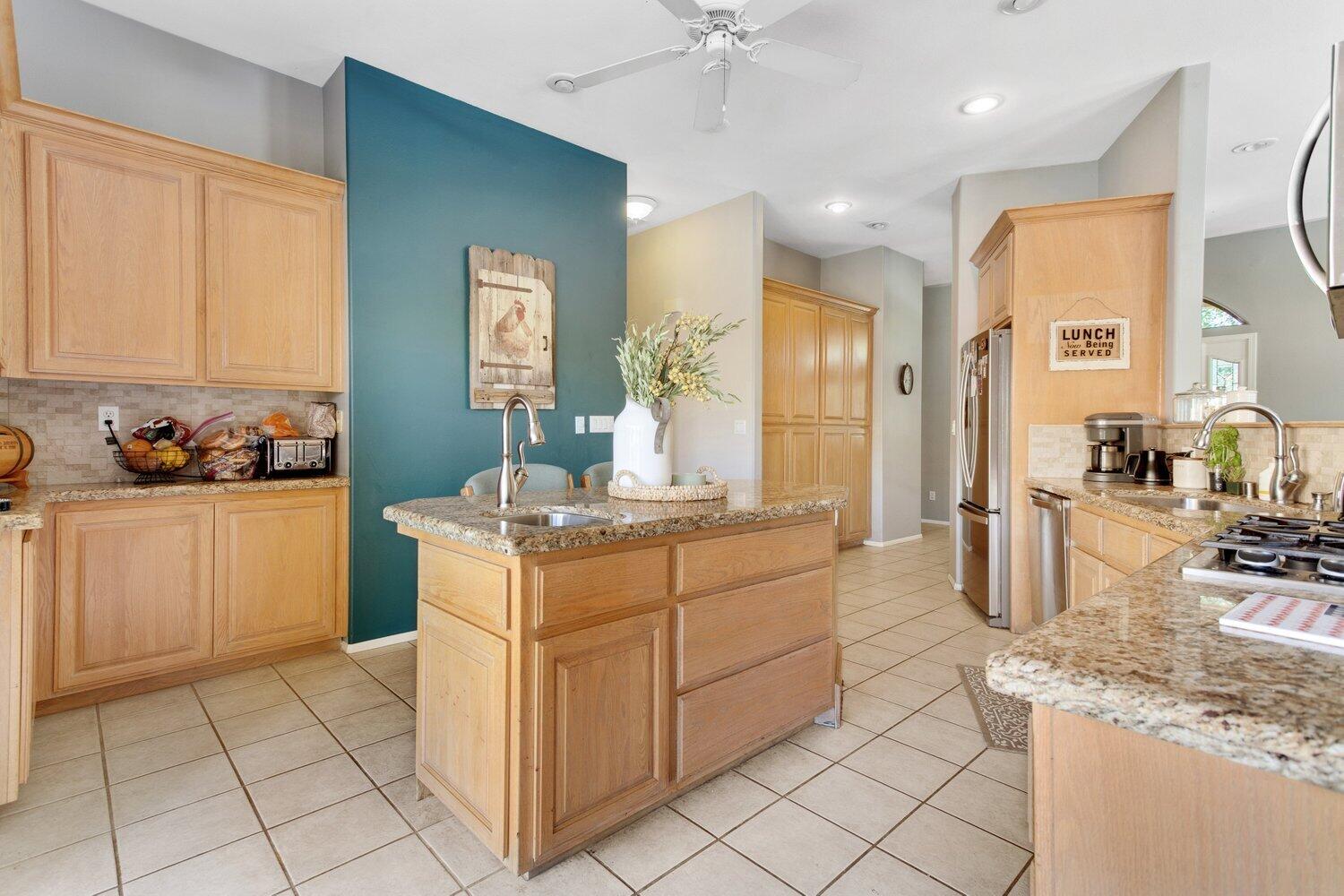 19510 Banducci Road Tehachapi, CA 93561 - Photo 17 of 75 a kitchen with kitchen island granite countertop a sink counter top space and cabinets