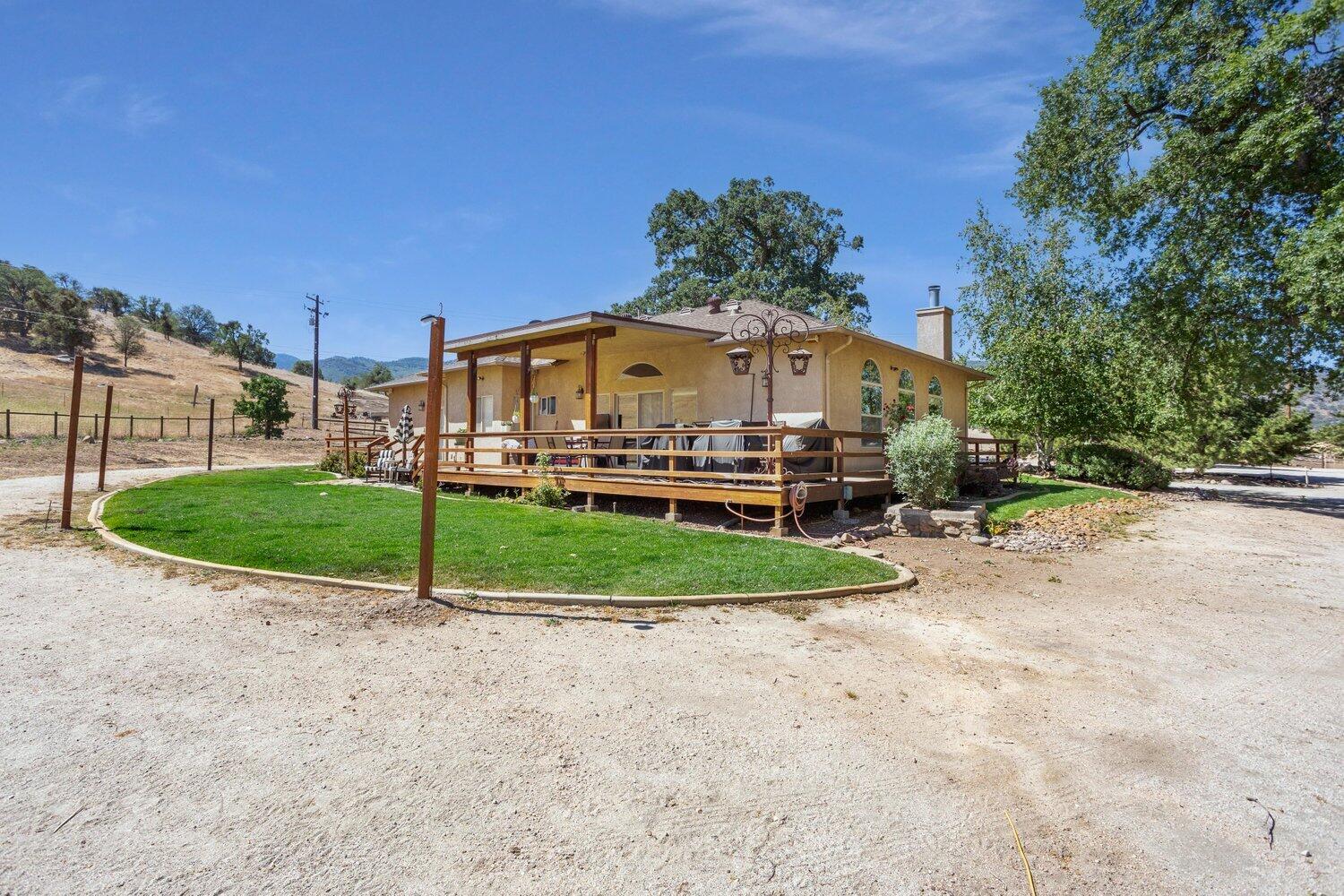 19510 Banducci Road Tehachapi, CA 93561 - Photo 36 of 75 a view of a house with a yard and table and chairs under an umbrella