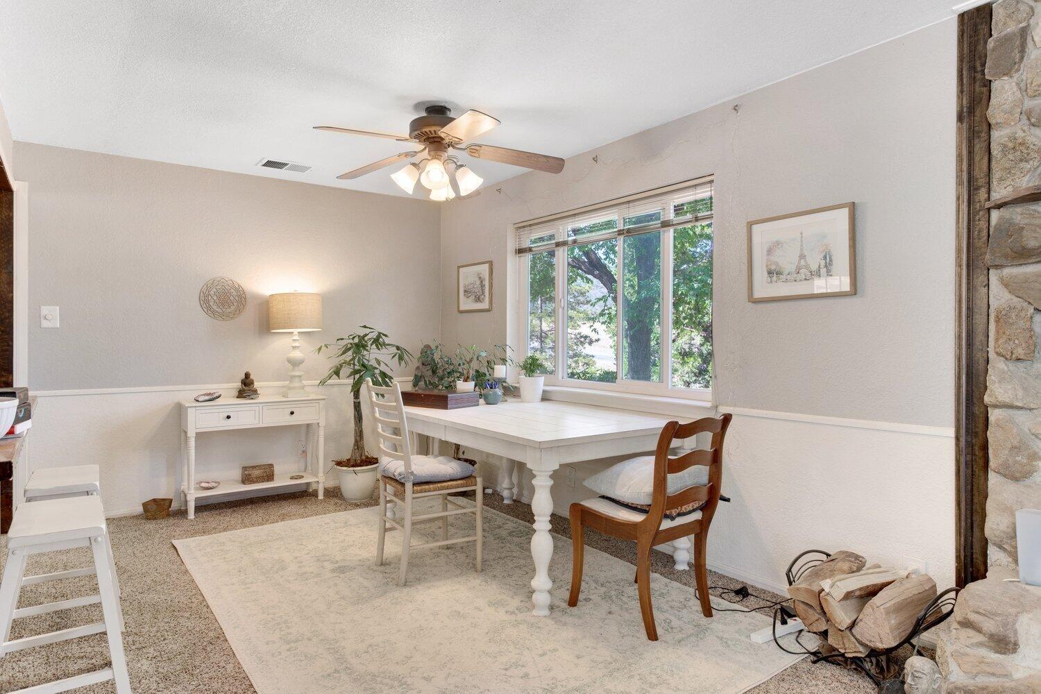 19510 Banducci Road Tehachapi, CA 93561 - Photo 49 of 75 a dining room with furniture a window and a chandelier
