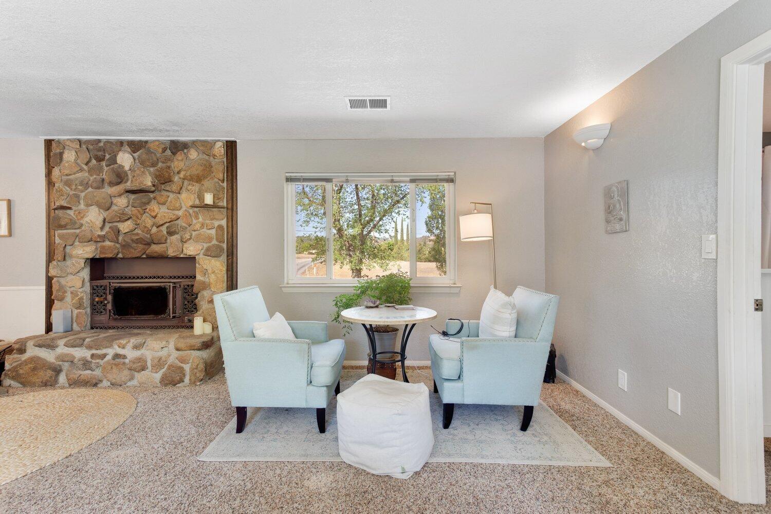 19510 Banducci Road Tehachapi, CA 93561 - Photo 51 of 75 a living room with furniture a fireplace and a large window