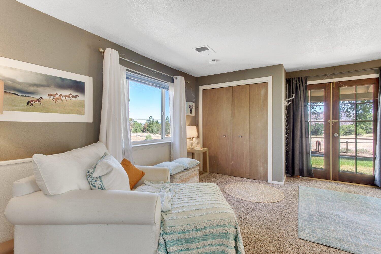 19510 Banducci Road Tehachapi, CA 93561 - Photo 60 of 75 a bedroom with a large bed and a large window