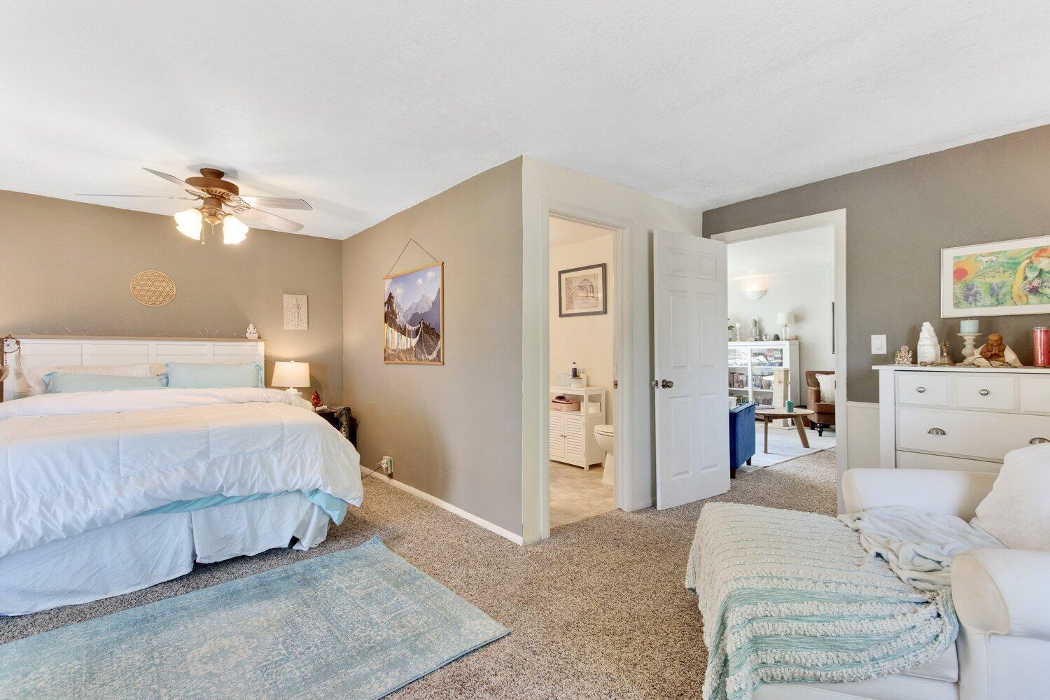 19510 Banducci Road Tehachapi, CA 93561 - Photo 61 of 75 a spacious bedroom with a bed and ceiling fan