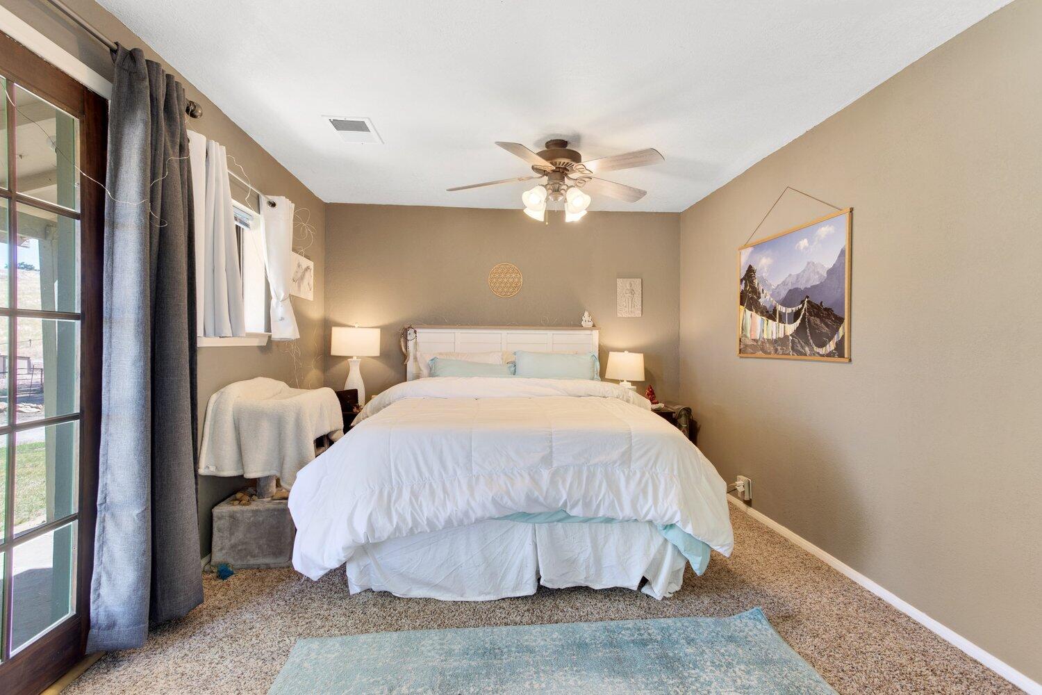 19510 Banducci Road Tehachapi, CA 93561 - Photo 62 of 75 a bedroom with a bed and a painting on the wall