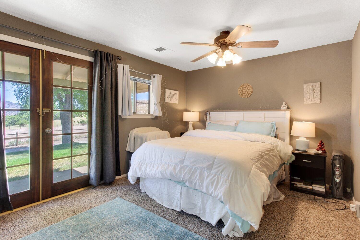 19510 Banducci Road Tehachapi, CA 93561 - Photo 63 of 75 a bedroom with a bed and a chandelier
