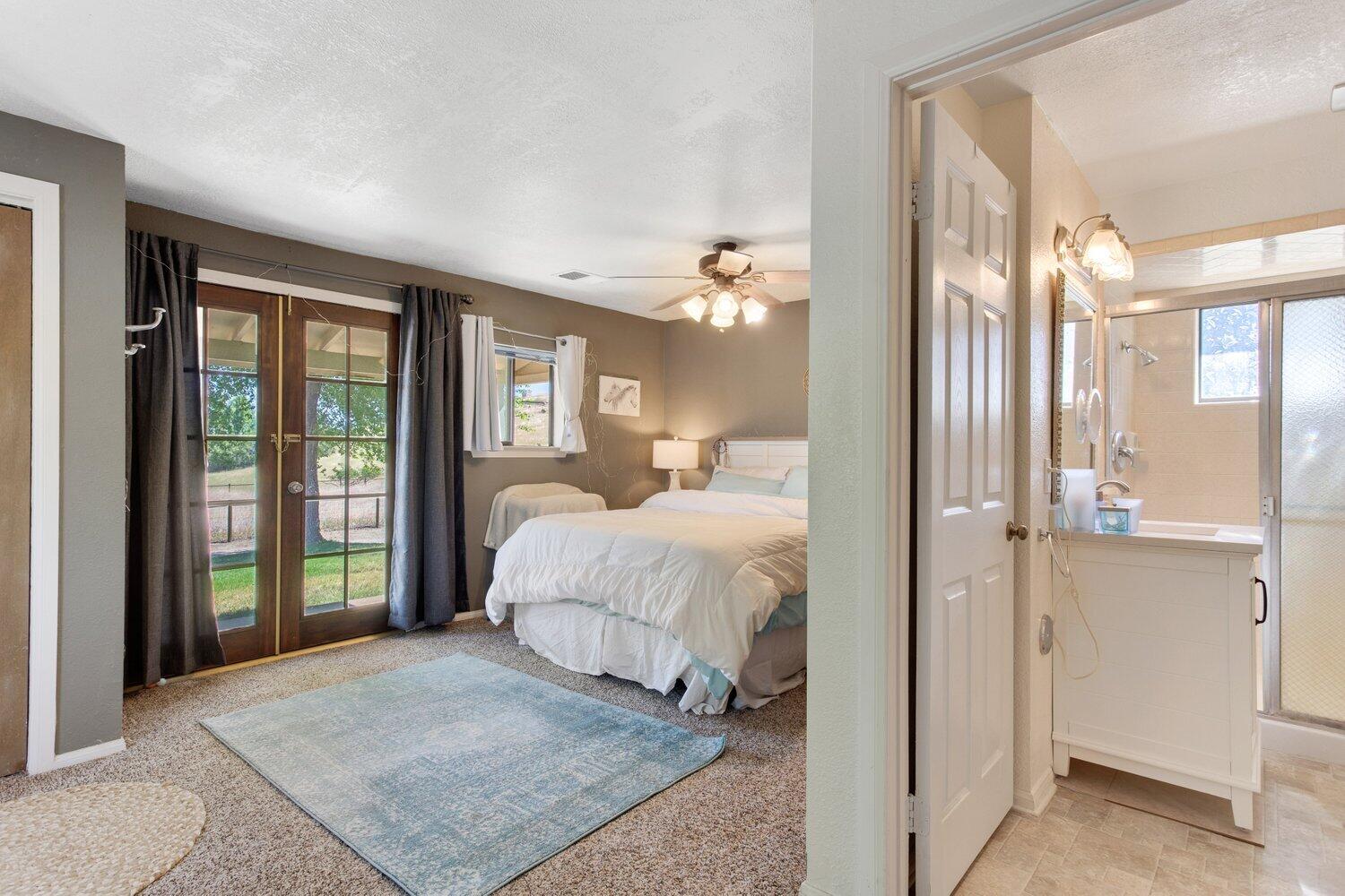 19510 Banducci Road Tehachapi, CA 93561 - Photo 66 of 75 a bedroom with a bed and glass walk in closet