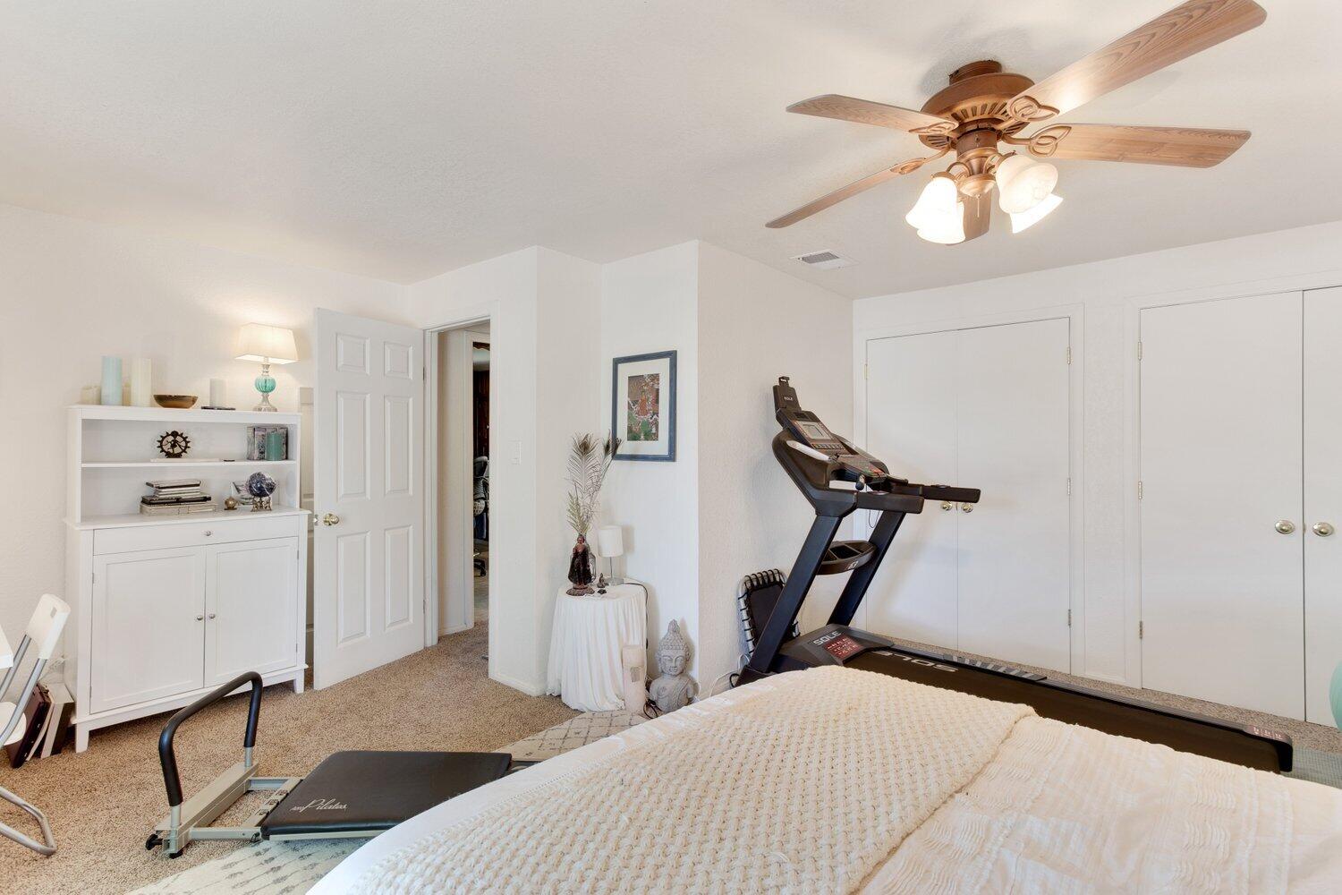 19510 Banducci Road Tehachapi, CA 93561 - Photo 69 of 75 a bedroom with a bed and a chandelier