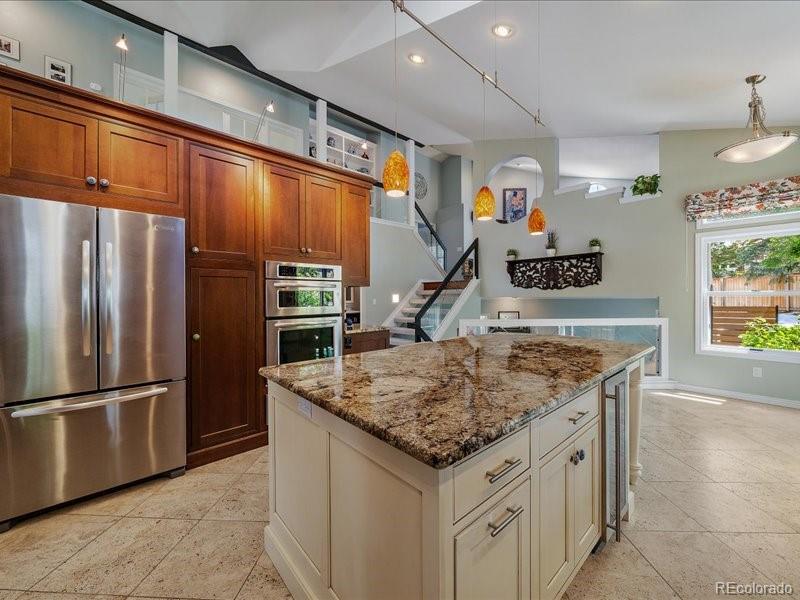 9306 Sulton Court Highlands Ranch, CO 80126 - Photo 12 of 48 a kitchen with stainless steel appliances granite countertop a refrigerator and a sink