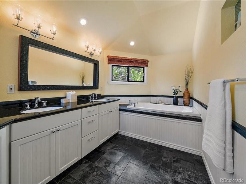 9306 Sulton Court Highlands Ranch, CO 80126 - Photo 20 of 48 a kitchen with stainless steel appliances white cabinets and sink