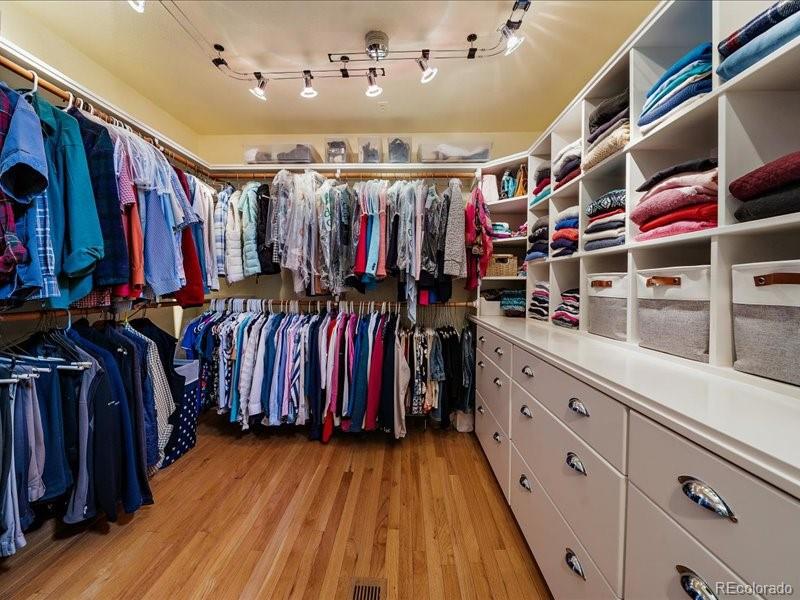 9306 Sulton Court Highlands Ranch, CO 80126 - Photo 23 of 48 a view of walk in closet with clothes and shoes