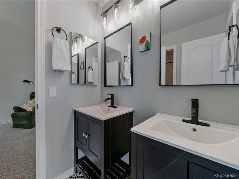 9306 Sulton Court Highlands Ranch, CO 80126 - Photo 27 of 48 a bathroom with a sink and a mirror