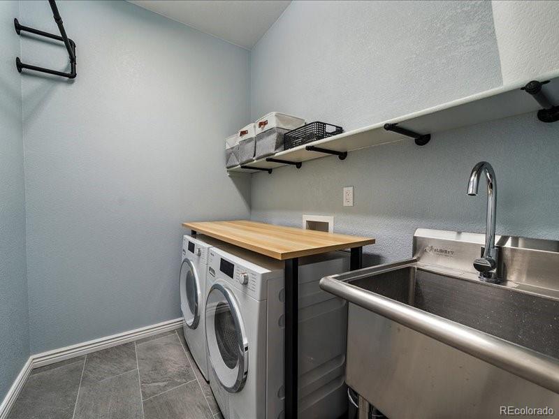 9306 Sulton Court Highlands Ranch, CO 80126 - Photo 35 of 48 a utility room with dryer and washer