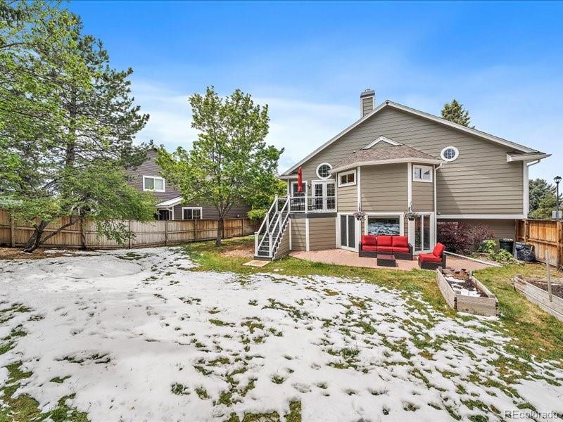 9306 Sulton Court Highlands Ranch, CO 80126 - Photo 41 of 48 a view of a house with a yard and pathway