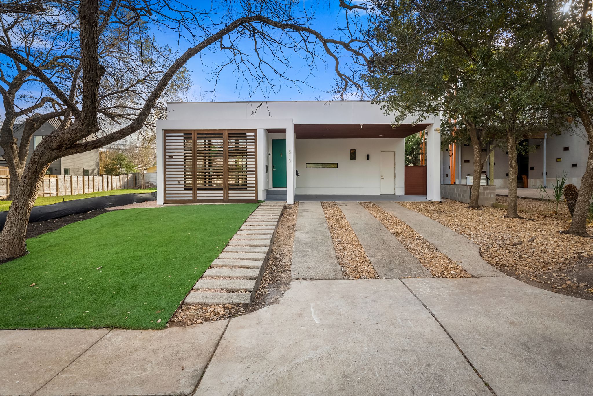 513 El Paso Street Austin, TX 78704 - Photo 2 of 34 a front view of a house with a garden and trees
