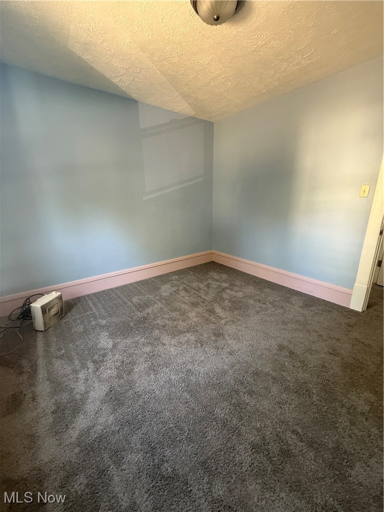746 Wooster Road North Barberton, OH 44203 - Photo 7 of 44 Empty room with a textured ceiling and carpet floors