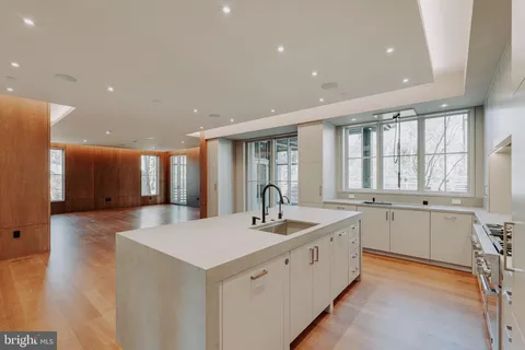 a large white kitchen with a large window