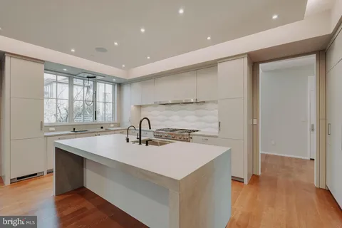 a kitchen with a sink stove and cabinets